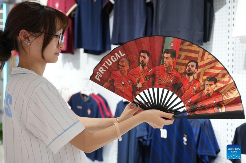 A vendor displays World Cup-themed merchandise at the Yiwu International Trade Market in Yiwu, east China's Zhejiang Province, May 15, 2026. As the 2026 FIFA World Cup draws near, World Cup-themed merchandise produced in Yiwu is in high demand. Yiwu is famous for small commodities manufacturing. According to local sources, most manufacturers began taking and producing orders related to the 2026 World Cup as early as last year, with products being shipped to markets around the world. (Xinhua/Huang Zongzhi)