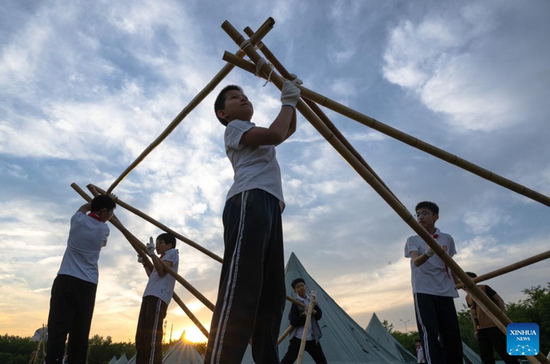 Sixth-grade students prepare for a graduation camping night event at a school in Wuchang District of Wuhan, central China's Hubei Province, May 15, 2026. The school held the event here on Friday for more than 300 sixth-grade students who are about to graduate. (Xinhua/Xiao Yijiu)