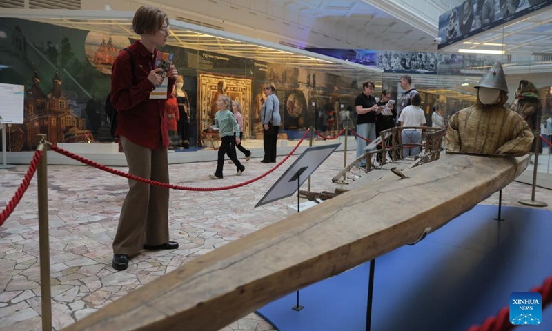 A visitor looks at an ancient canoe at the Russian Museum of Ethnography in St. Petersburg, Russia, May 16, 2026. During the Night of Museums, an event held from May 16 to 17 in Russia, more than 140 museums, galleries, libraries, exhibition halls and concert halls stay open from evening till night, to mark the upcoming International Museum Day, observed globally on May 18. (Photo by Irina Motina/Xinhua)