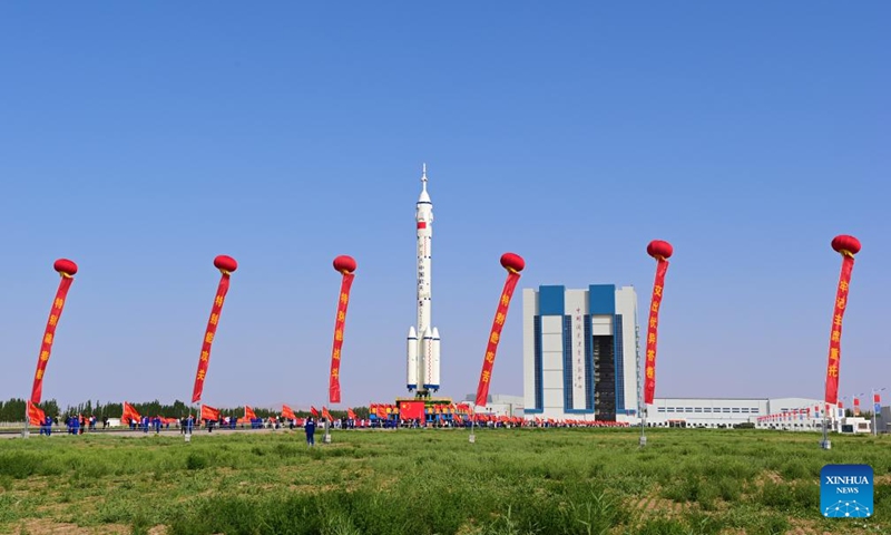 This photo taken on May 16, 2026 shows the combination of the Shenzhou-23 crewed spaceship and a Long March-2F carrier rocket being transferred to the launching area. (Photo by Wang Jiangbo/Xinhua)