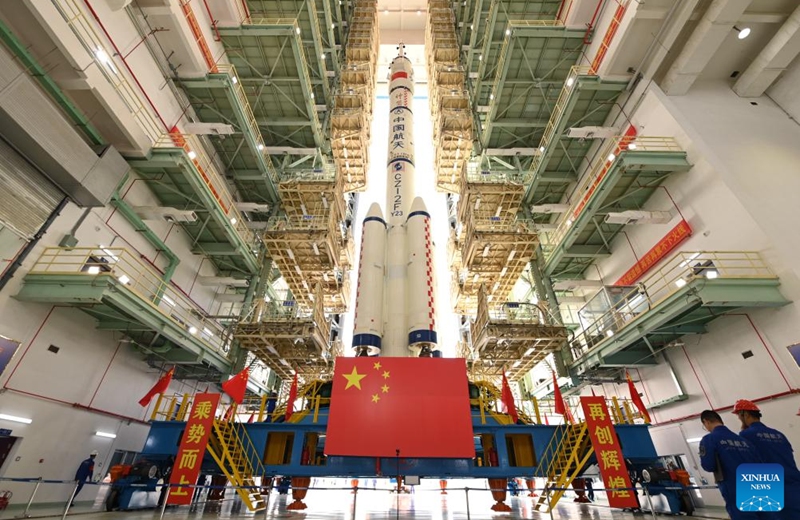 This photo taken on May 16, 2026 shows the combination of the Shenzhou-23 crewed spaceship and a Long March-2F carrier rocket to be transferred to the launching area. (Photo by Wang Jiangbo/Xinhua)