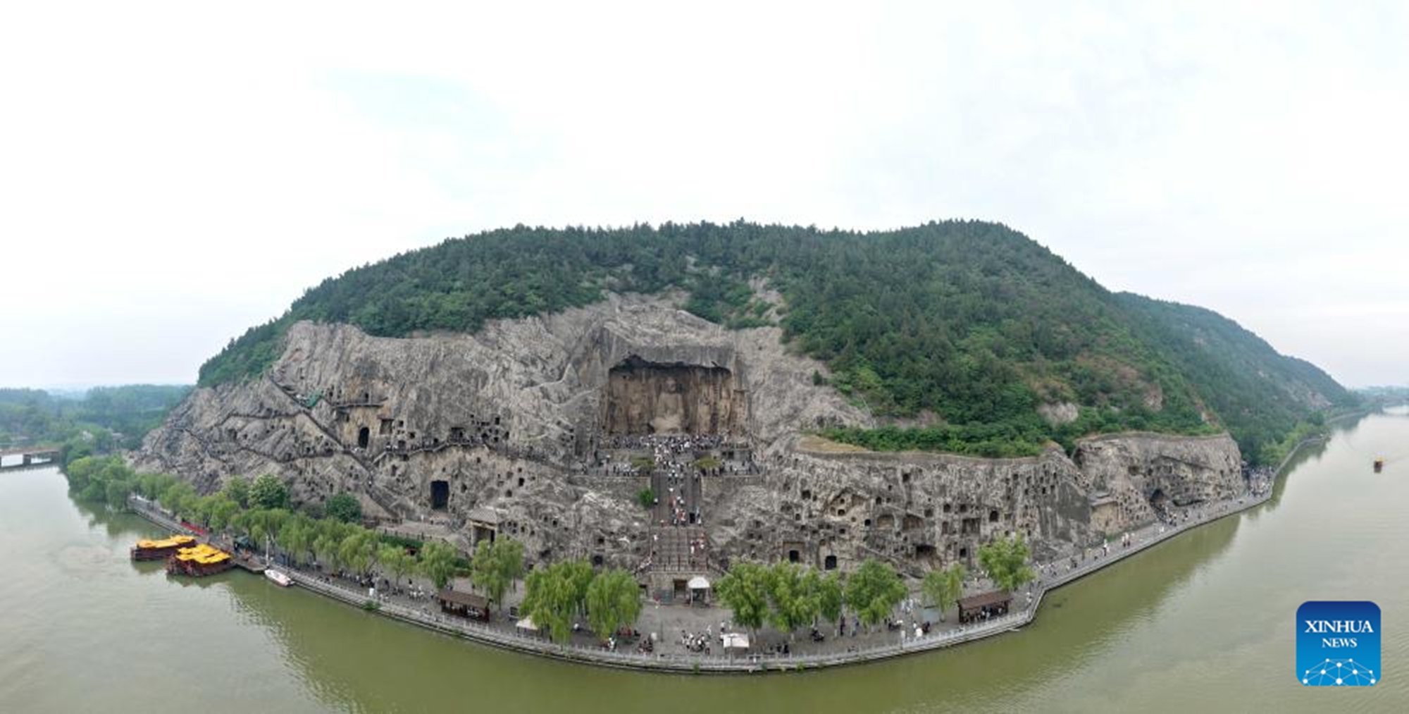 A drone photo taken on May 13, 2026 shows tourists visiting Longmen Grottoes in Luoyang, central China's Henan Province. (Xinhua/Li Jianan)