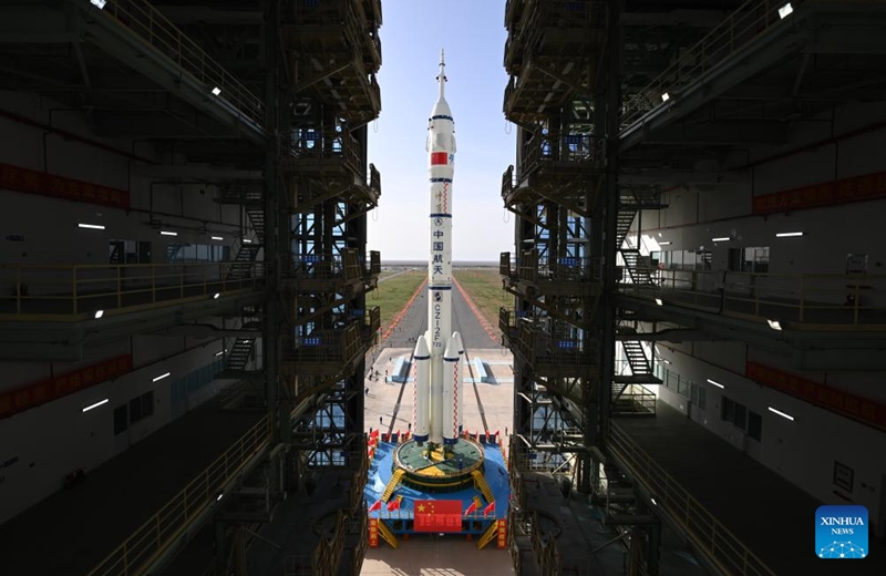 This photo taken on May 16, 2026 shows the combination of the Shenzhou-23 crewed spaceship and a Long March-2F carrier rocket being transferred to the launching area. (Photo by Wang Jiangbo/Xinhua)
