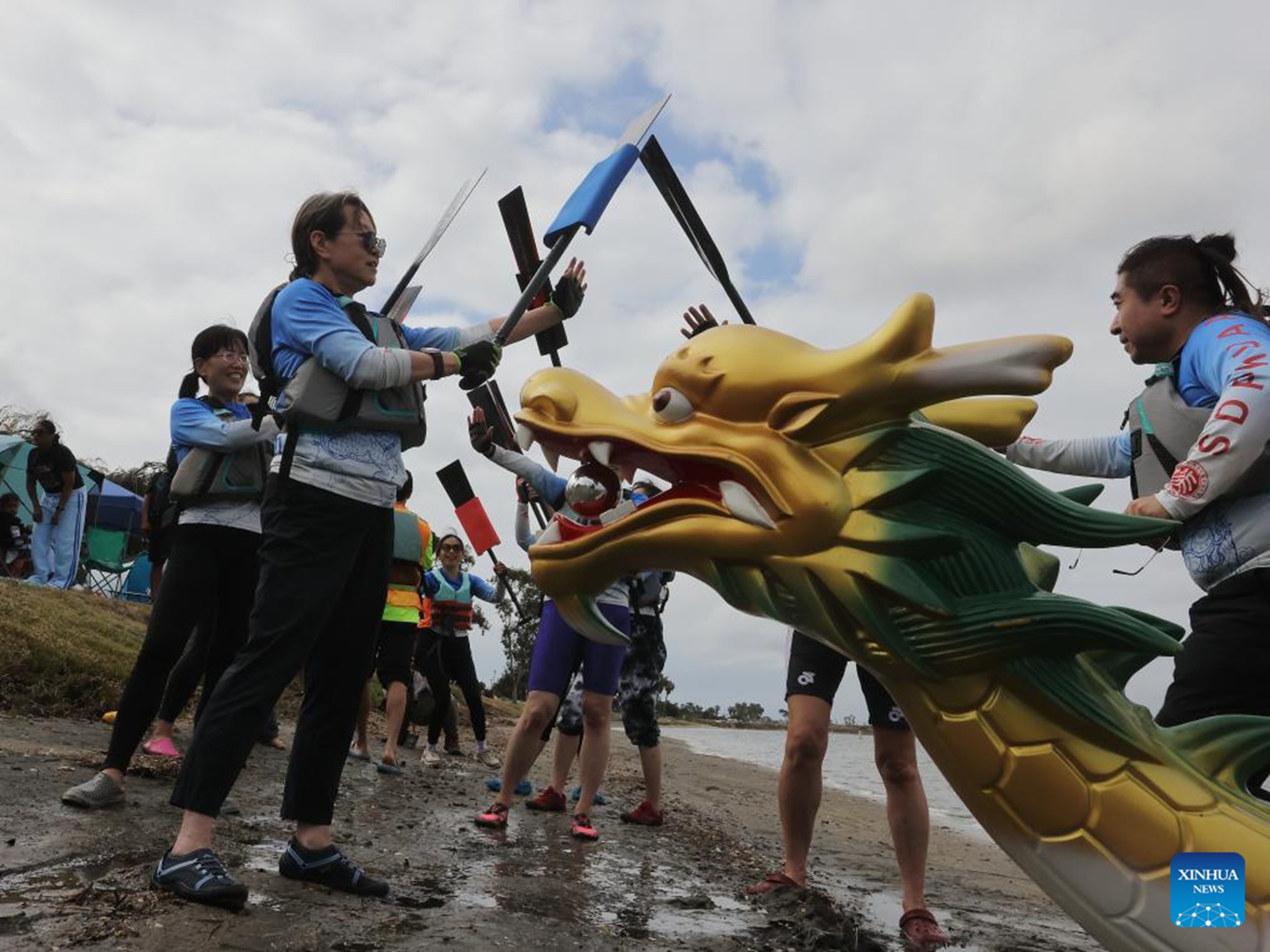 Contestants celebrate after their competition during the annual San Diego Dragon Boat Festival at Mission Bay in San Diego, California, the United States, on May 16, 2026. (Photo by Qiu Chen/Xinhua)

