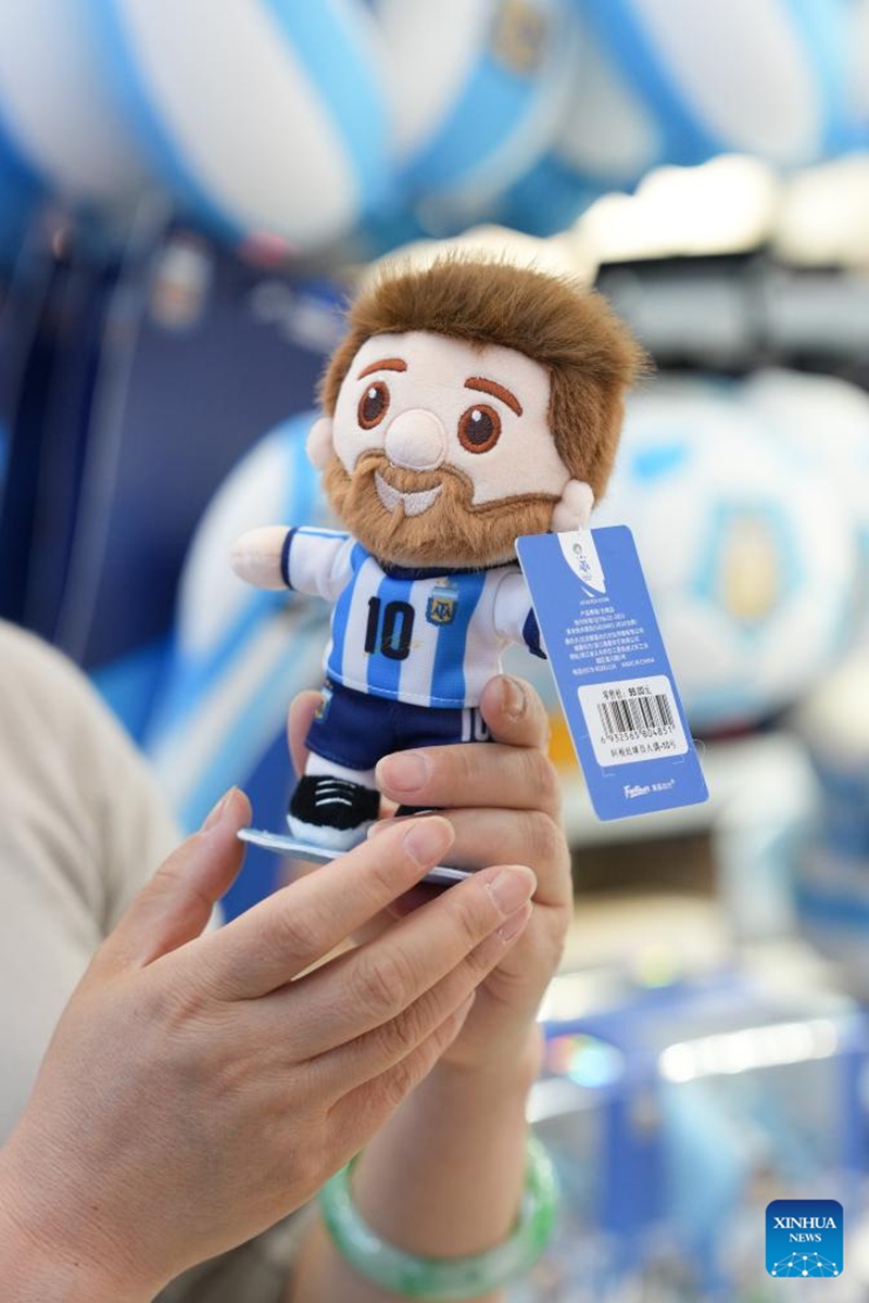 A vendor displays World Cup-themed merchandise at the Yiwu International Trade Market in Yiwu, east China's Zhejiang Province, May 15, 2026. As the 2026 FIFA World Cup draws near, World Cup-themed merchandise produced in Yiwu is in high demand. Yiwu is famous for small commodities manufacturing. According to local sources, most manufacturers began taking and producing orders related to the 2026 World Cup as early as last year, with products being shipped to markets around the world. (Xinhua/Huang Zongzhi)