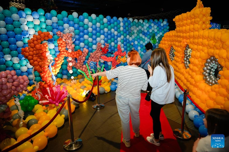 Visitors view underwater world-themed balloon installations during the World Balloon Festival in Warsaw, Poland, May 15, 2026. The festival takes place here from May 15 to 17, featuring large themed installations featuring tropical jungles, underwater world, outer space and architectural landmarks created with more than 100,000 biodegradable balloons. (Photo by Jaap Arriens/Xinhua)