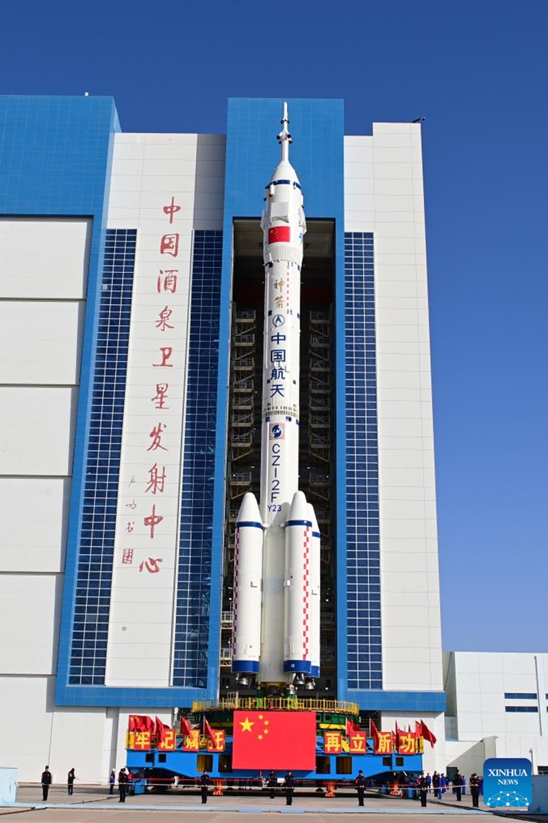 This photo taken on May 16, 2026 shows the combination of the Shenzhou-23 crewed spaceship and a Long March-2F carrier rocket being transferred to the launching area. (Photo by Wang Jiangbo/Xinhua)