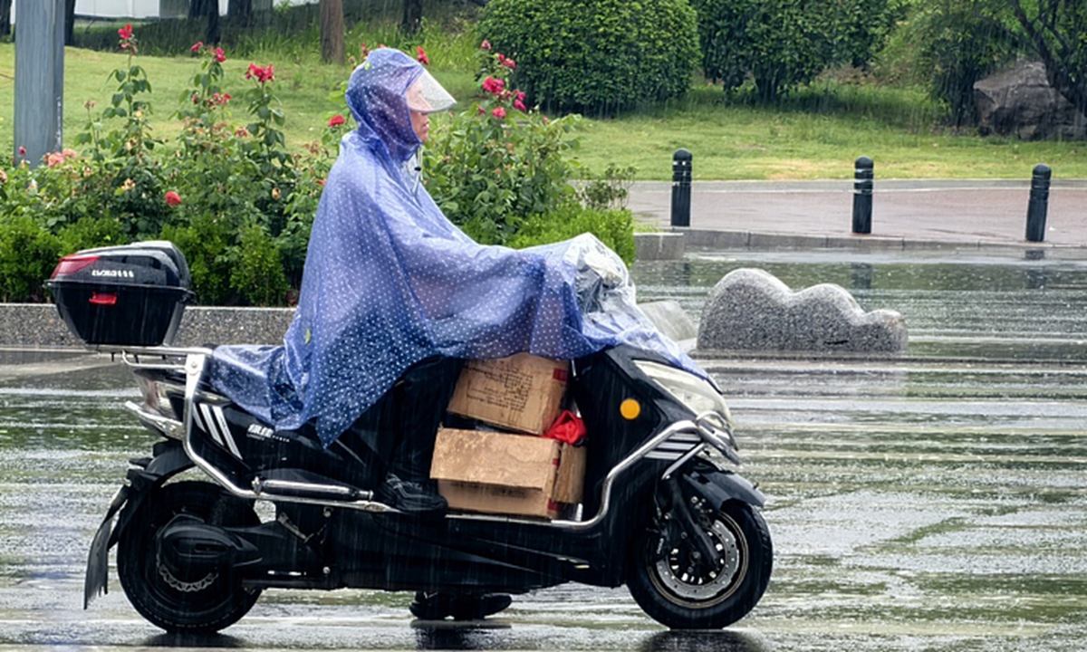 A resident rides a motorbike in the rain in Zhengzhou, Central China's Henan Province on May 17, 2026. Photo: VCG