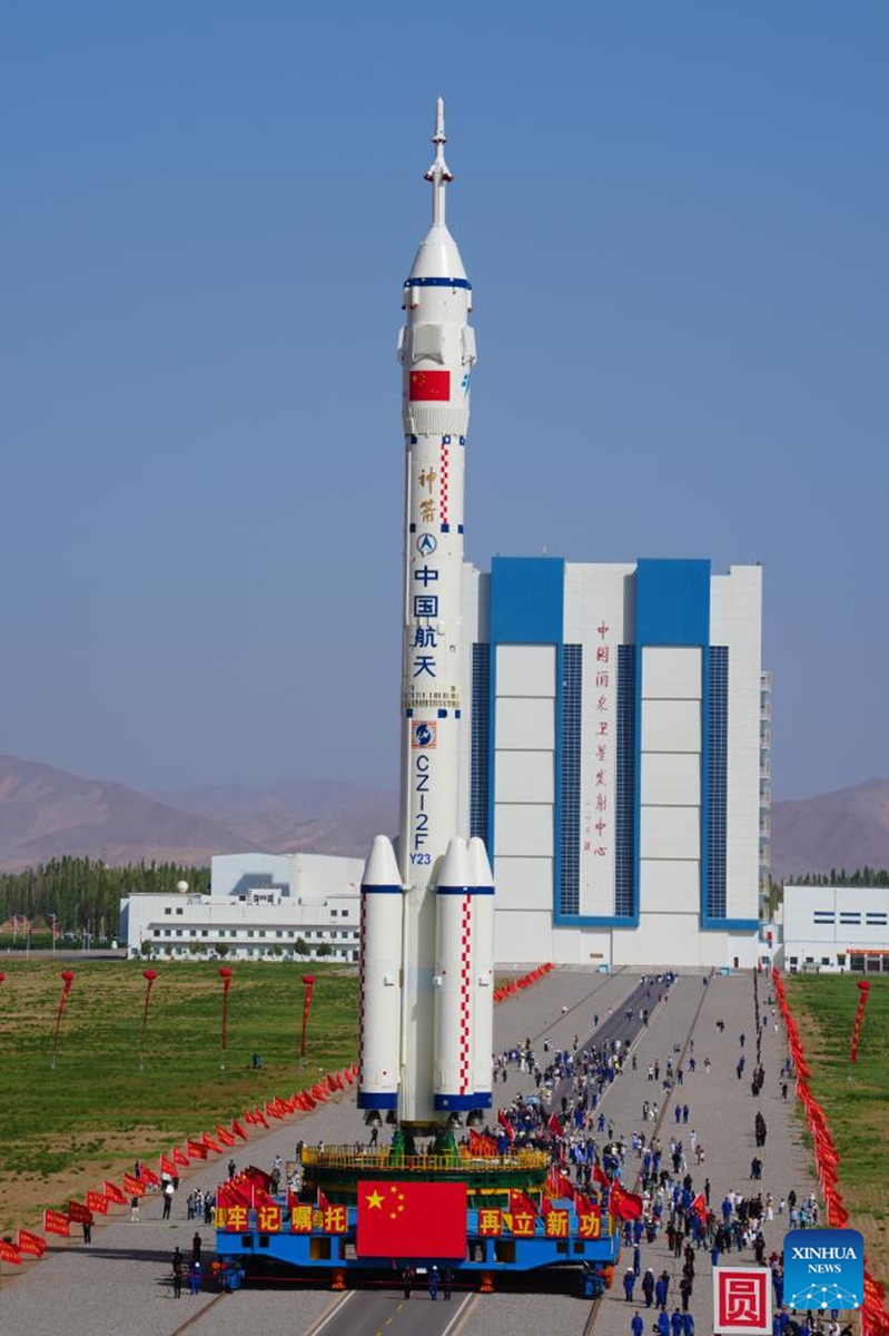 This photo taken on May 16, 2026 shows the combination of the Shenzhou-23 crewed spaceship and a Long March-2F carrier rocket being transferred to the launching area. (Photo by Wang Jiangbo/Xinhua)