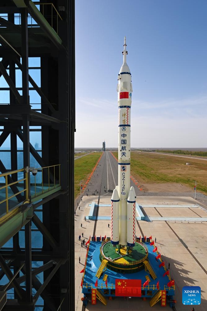 This photo taken on May 16, 2026 shows the combination of the Shenzhou-23 crewed spaceship and a Long March-2F carrier rocket being transferred to the launching area. (Photo by Wang Jiangbo/Xinhua)