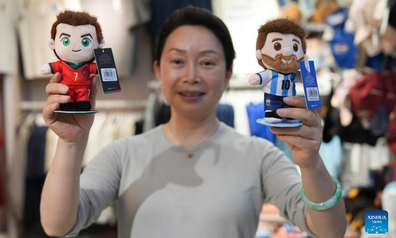 A vendor displays World Cup-themed merchandise at the Yiwu International Trade Market in Yiwu, east China's Zhejiang Province, May 15, 2026. As the 2026 FIFA World Cup draws near, World Cup-themed merchandise produced in Yiwu is in high demand. Yiwu is famous for small commodities manufacturing. According to local sources, most manufacturers began taking and producing orders related to the 2026 World Cup as early as last year, with products being shipped to markets around the world. (Xinhua/Huang Zongzhi)