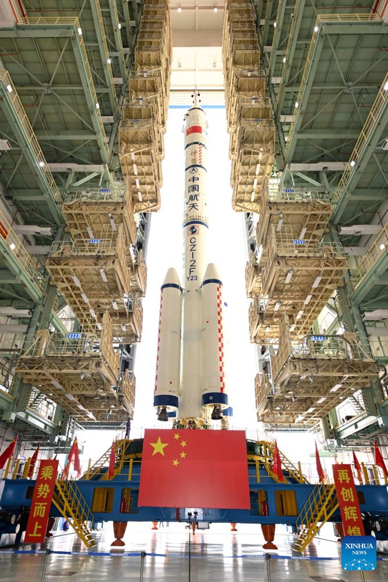 This photo taken on May 16, 2026 shows the combination of the Shenzhou-23 crewed spaceship and a Long March-2F carrier rocket to be transferred to the launching area. (Photo by Wang Jiangbo/Xinhua)
