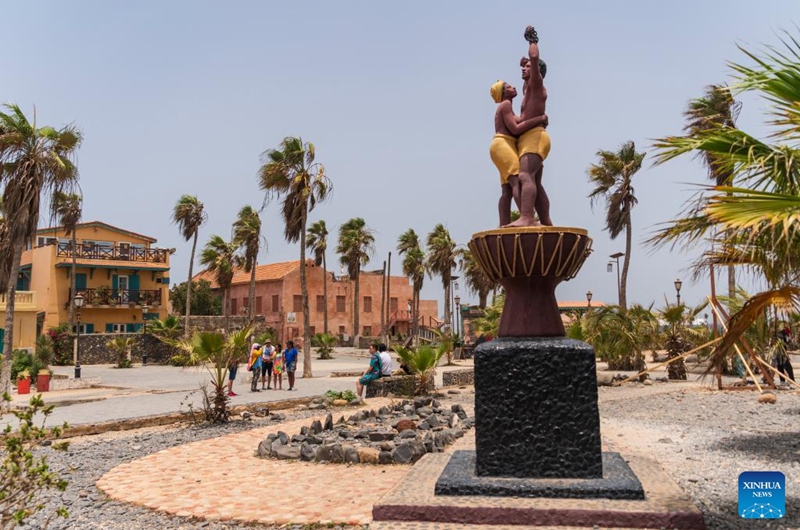 Tourists are seen near the Statue of the Liberation from Slavery on Goree Island in Senegal, May 16, 2026. Goree Island lies off the coast of Senegal, opposite Dakar. Ruled in succession by the Portuguese, Dutch, English and French, it was the largest slave-trading center on the African coast from the 15th to the 19th century. (Xinhua/Xie Jianfei)