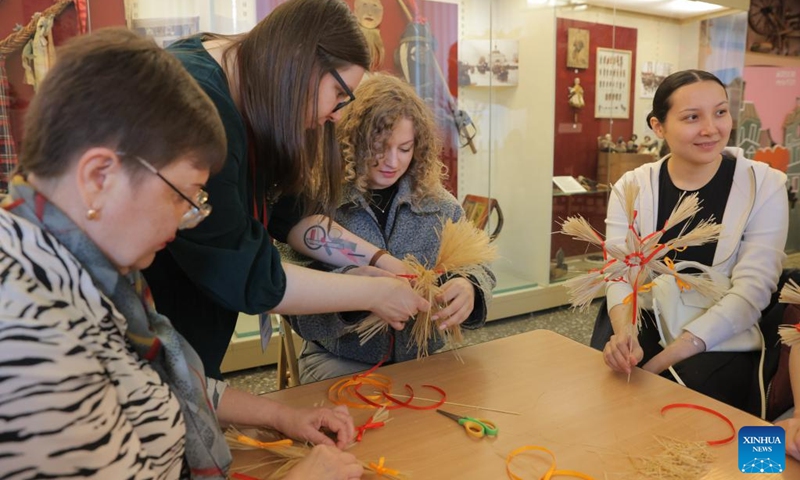 Visitors learn to make ethnic handicrafts at the Russian Museum of Ethnography in St. Petersburg, Russia, May 16, 2026. During the Night of Museums, an event held from May 16 to 17 in Russia, more than 140 museums, galleries, libraries, exhibition halls and concert halls stay open from evening till night, to mark the upcoming International Museum Day, observed globally on May 18. (Photo by Irina Motina/Xinhua)