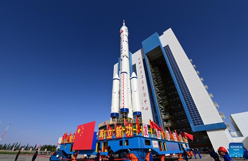 This photo taken on May 16, 2026 shows the combination of the Shenzhou-23 crewed spaceship and a Long March-2F carrier rocket being transferred to the launching area. (Photo by Wang Jiangbo/Xinhua)
