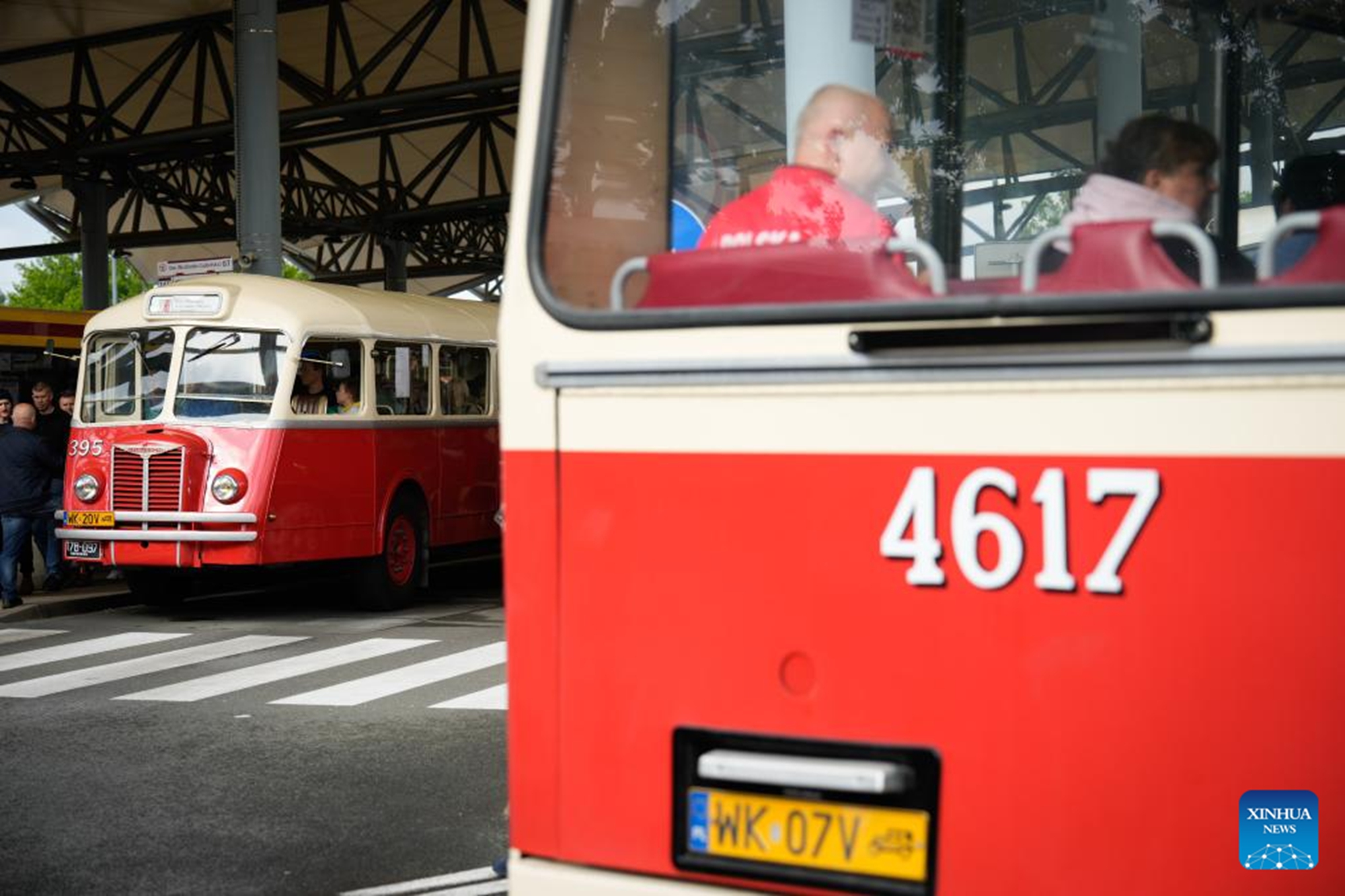 People ride a vintage bus in Warsaw, Poland, on May 16, 2026. Vintage bus-riding event in Warsaw attracts residents and tourists to experience the history of public transportation. (Photo by Jaap Arriens/Xinhua)