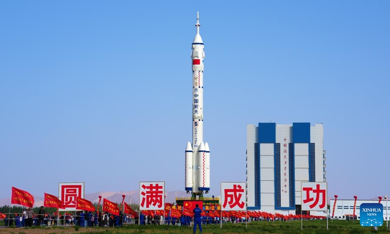 This photo taken on May 16, 2026 shows the combination of the Shenzhou-23 crewed spaceship and a Long March-2F carrier rocket being transferred to the launching area. (Photo by Wang Jiangbo/Xinhua)