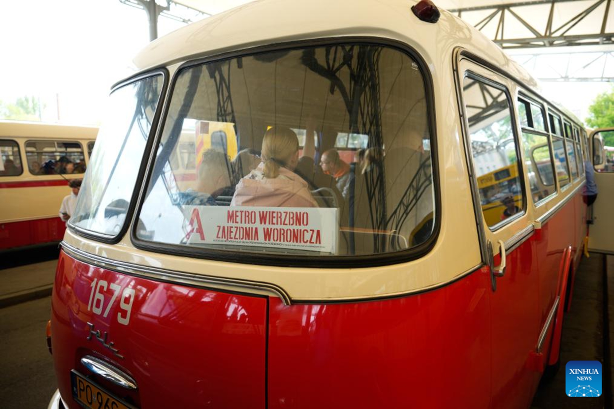 People ride a vintage bus in Warsaw, Poland, on May 16, 2026. Vintage bus-riding event in Warsaw attracts residents and tourists to experience the history of public transportation. (Photo by Jaap Arriens/Xinhua)
