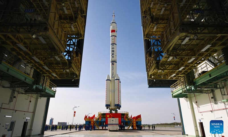 This photo taken on May 16, 2026 shows the combination of the Shenzhou-23 crewed spaceship and a Long March-2F carrier rocket being transferred to the launching area. (Photo by Wang Jiangbo/Xinhua)