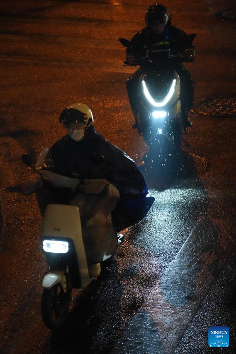 People ride in the rain in Beijing, capital of China, May 16, 2026. The Beijing meteorological observatory issued a blue alert for rainstorms Saturday afternoon, warning that parts of the capital could see rainfall of more than 50 mm from Sunday daytime through the night, with some areas expected to receive more than 70 mm. (Xinhua/Xie Han)