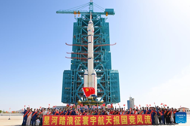This photo taken on May 16, 2026 shows the combination of the Shenzhou-23 crewed spaceship and a Long March-2F carrier rocket transferred to the launching area. (Photo by Wang Jiangbo/Xinhua)