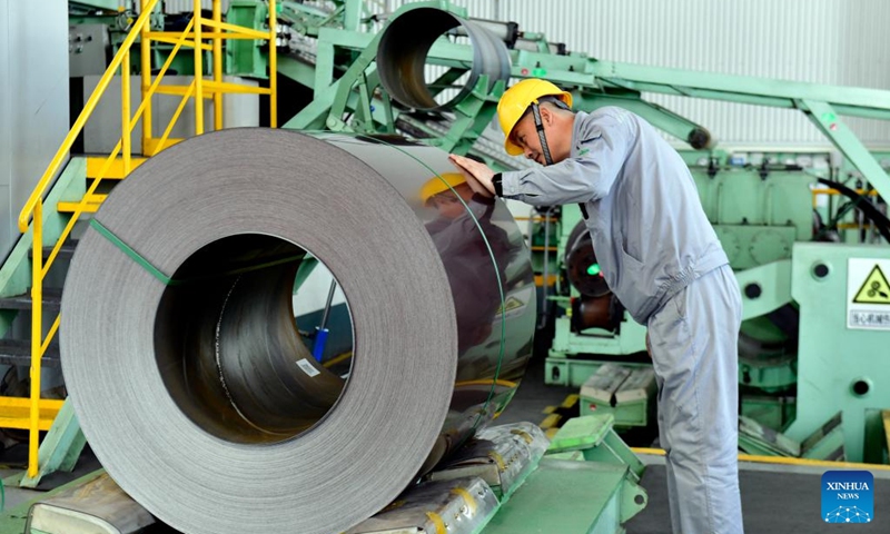 A worker checks color-coated steel plates at the workshop of Shandong Xinmeida Technology Materials Co. Ltd. in Binzhou, east China's Shandong Province, Feb. 26, 2025. Binzhou City is a major hub for private enterprises. In recent years, the city has fostered the development of private economy through comprehensive and end-to-end services. (Photo: Xinhua)

