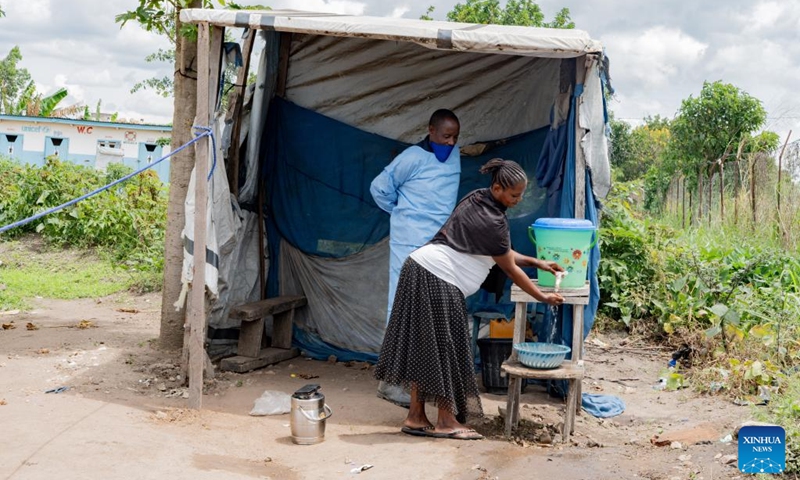 A health worker instructs a local resident to wash hands at the general reference hospital in Rwampara in eastern Democratic Republic of the Congo, on May 16, 2026. The death toll from the latest Ebola outbreak in the Democratic Republic of the Congo (DRC) has risen to 87, the Africa Centers for Disease Control and Prevention (Africa CDC) said Saturday, warning that the outbreak is driven by the Bundibugyo strain, for which no strain-specific vaccine is currently available, and that it carries a high risk of regional spread. (Str/Xinhua)