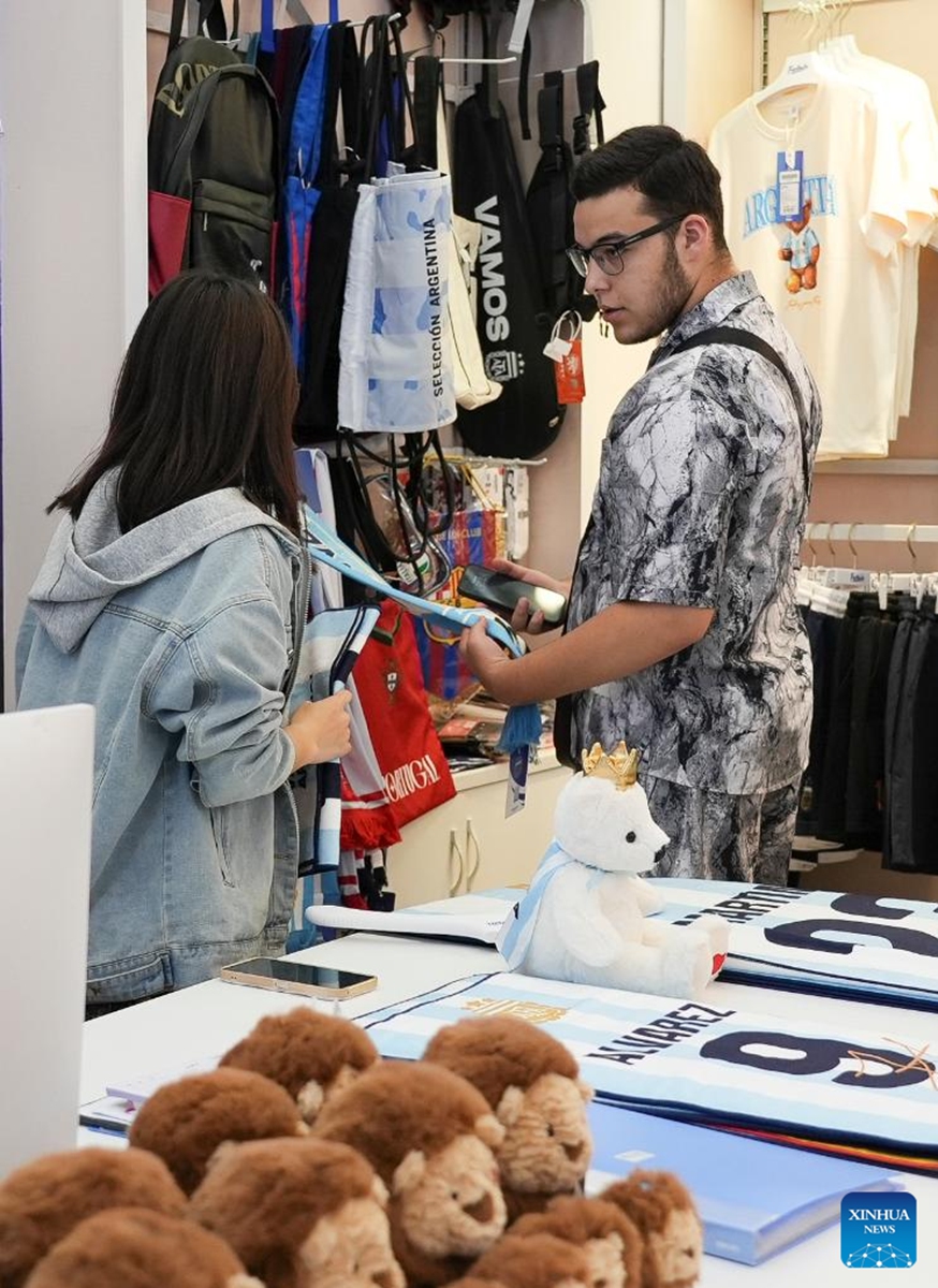 A man shops at the Yiwu International Trade Market in Yiwu, east China's Zhejiang Province, May 15, 2026. As the 2026 FIFA World Cup draws near, World Cup-themed merchandise produced in Yiwu is in high demand. Yiwu is famous for small commodities manufacturing. According to local sources, most manufacturers began taking and producing orders related to the 2026 World Cup as early as last year, with products being shipped to markets around the world. (Xinhua/Hu Xingyu)