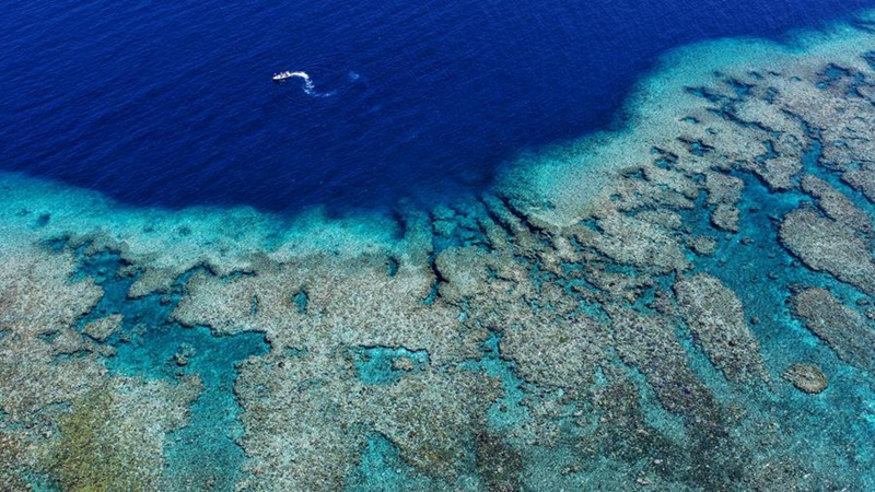 An aerial drone photo taken on April 28, 2026 shows a boat deployed by the China Coast Guard (CCG) vessel Chuanshan patrolling around reefs in the territorial waters of China's Huangyan Dao in the South China Sea. (Xinhua/Chen Bin)