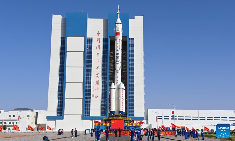 This photo taken on May 16, 2026 shows the combination of the Shenzhou-23 crewed spaceship and a Long March-2F carrier rocket being transferred to the launching area. (Photo by Wang Jiangbo/Xinhua)