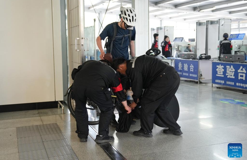 Staff members help a passenger remove the bicycle cover at Shichang Station of Beijing Subway in Beijing, capital of China, May 16, 2026. Beijing launched a pilot service on May 10 that allows passengers to bring their bicycles onto the subway train, as the number of cycling enthusiasts and demand for cross-district rides grow in the capital.

According to the Beijing Municipal Commission of Transport, starting May 10, passengers can bring single-seat, human-powered two-wheel bicycles with a wheel diameter of up to 28 inches (about 71 cm) onto subway trains at 11 pilot stations across four lines, namely Line 6, Line 17, the Changping Line and the S1 Line. Photo: Xinhua