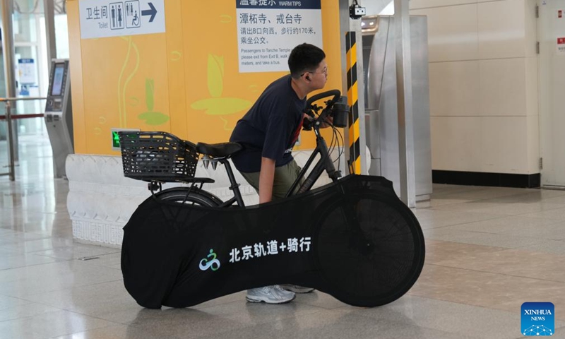 A passenger exits Shichang Station of Beijing Subway with a bicycle in Beijing, capital of China, May 16, 2026. Beijing launched a pilot service on May 10 that allows passengers to bring their bicycles onto the subway train, as the number of cycling enthusiasts and demand for cross-district rides grow in the capital.

According to the Beijing Municipal Commission of Transport, starting May 10, passengers can bring single-seat, human-powered two-wheel bicycles with a wheel diameter of up to 28 inches (about 71 cm) onto subway trains at 11 pilot stations across four lines, namely Line 6, Line 17, the Changping Line and the S1 Line. Photo: Xinhua