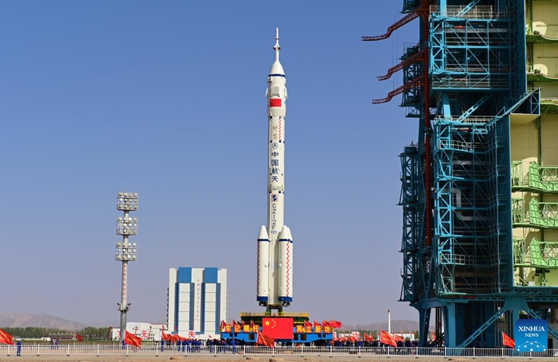This photo taken on May 16, 2026 shows the combination of the Shenzhou-23 crewed spaceship and a Long March-2F carrier rocket being transferred to the launching area. (Photo by Wang Jiangbo/Xinhua)