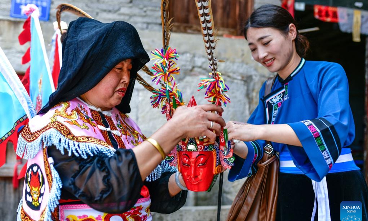 Villagers arrange a mask before rehearsing Dixi opera in Wujiatun of Zhangzhuang Village, Qiyanqiao Town of Anshun City, southwest China's Guizhou Province, May 14, 2026. (Xinhua/Yang Wenbin)

