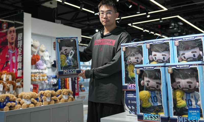 A vendor displays World Cup-themed merchandise at the Yiwu International Trade Market in Yiwu, east China's Zhejiang Province, May 15, 2026. As the 2026 FIFA World Cup draws near, World Cup-themed merchandise produced in Yiwu is in high demand. Yiwu is famous for small commodities manufacturing. According to local sources, most manufacturers began taking and producing orders related to the 2026 World Cup as early as last year, with products being shipped to markets around the world. (Xinhua/Huang Zongzhi)