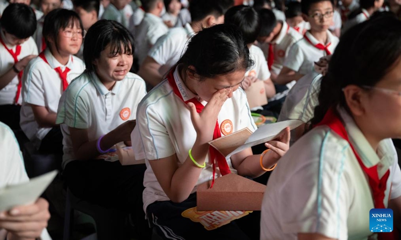 Sixth-grade students are seen in tears as they read letters from parents during a graduation camping night event at a school in Wuchang District of Wuhan, central China's Hubei Province, May 15, 2026. The school held the event here on Friday for more than 300 sixth-grade students who are about to graduate. (Xinhua/Xiao Yijiu)
