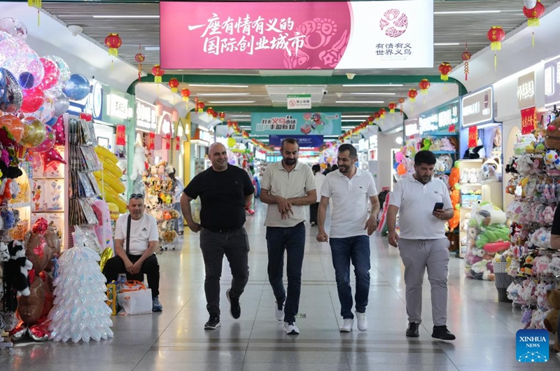 People shop at the Yiwu International Trade Market in Yiwu, east China's Zhejiang Province, May 15, 2026. As the 2026 FIFA World Cup draws near, World Cup-themed merchandise produced in Yiwu is in high demand. Yiwu is famous for small commodities manufacturing. According to local sources, most manufacturers began taking and producing orders related to the 2026 World Cup as early as last year, with products being shipped to markets around the world. (Xinhua/Huang Zongzhi)