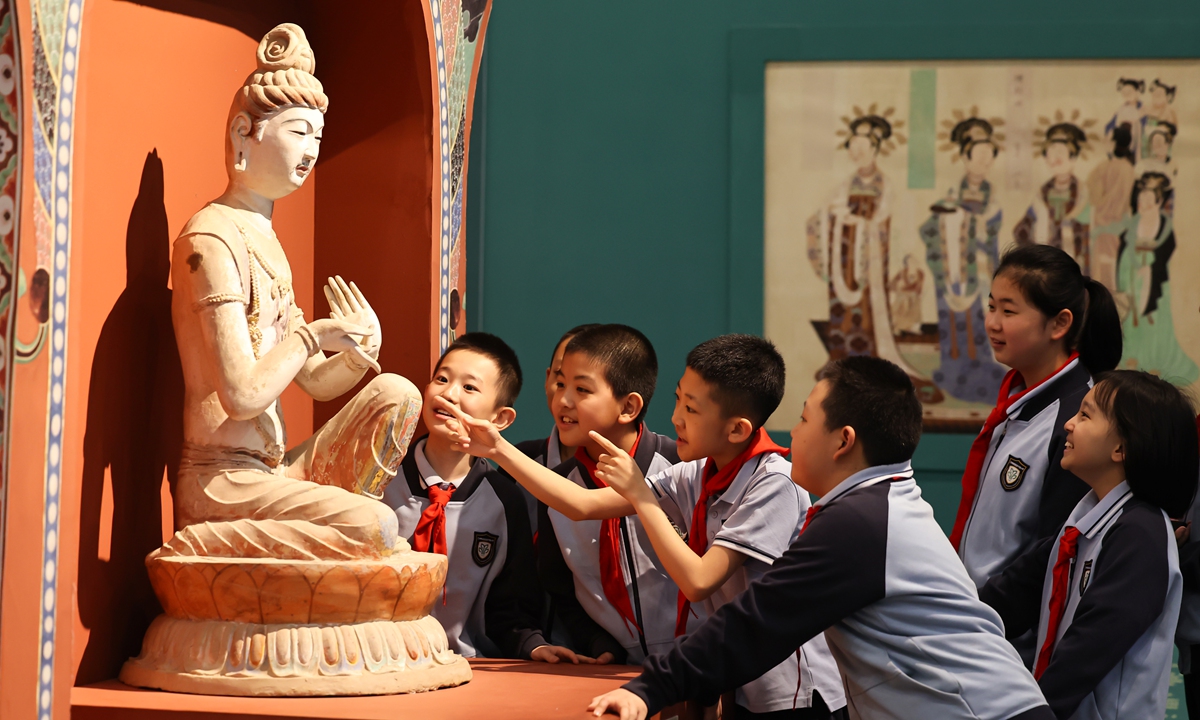 Students observe a Buddha statue at the Dunhuang Art Gallery, part of the Dunhuang Academy, during a themed study tour event in Lanzhou, Northwest China's Gansu Province, on May 18, 2026, International Museum Day. Photo: VCG