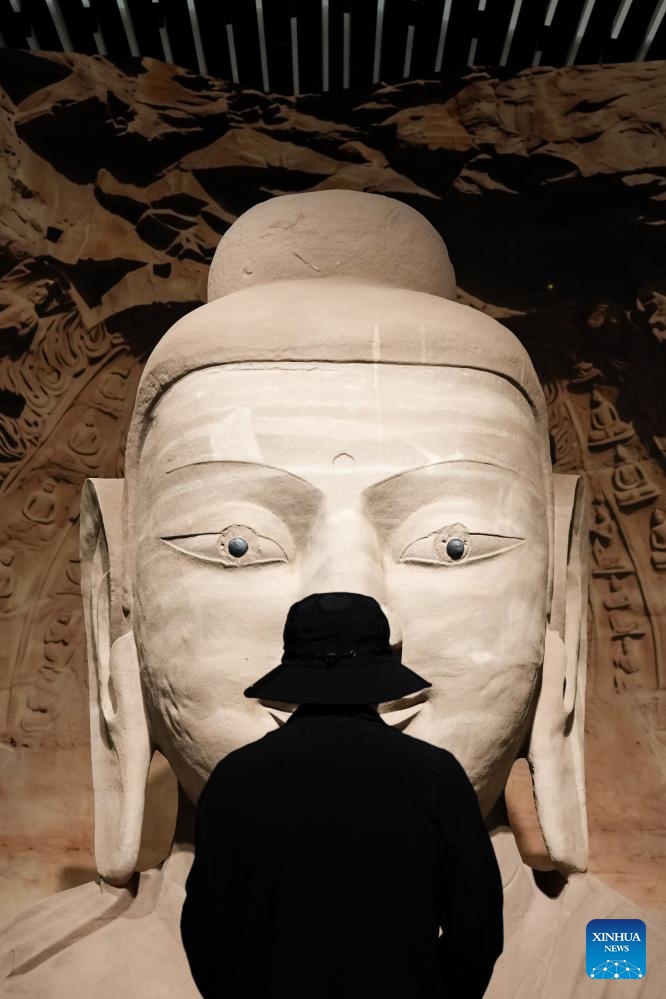 A visitor visits the exhibition Yungang Grottoes: A world heritage site from the Pingcheng era of the Northern Wei Dynasty at the Sanxingdui Museum in Guanghan City, southwest China's Sichuan Province, May 18, 2026. Presenting over 120 pieces (sets) of exhibits, the exhibition kicked off here on Monday and will last till Oct. 31. (Photo: Xinhua)