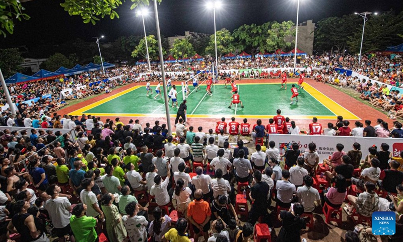 People watch a volleyball match at Longlou Town, Wenchang, south China's Hainan Province, July 1, 2023. Wenchang in south China's Hainan is a renowned hometown of overseas Chinese, where cultures brought back by overseas Chinese from Southeast Asia have merged with the indigenous ones to form some very interesting customs in diet and entertainment. (Photo: Xinhua)