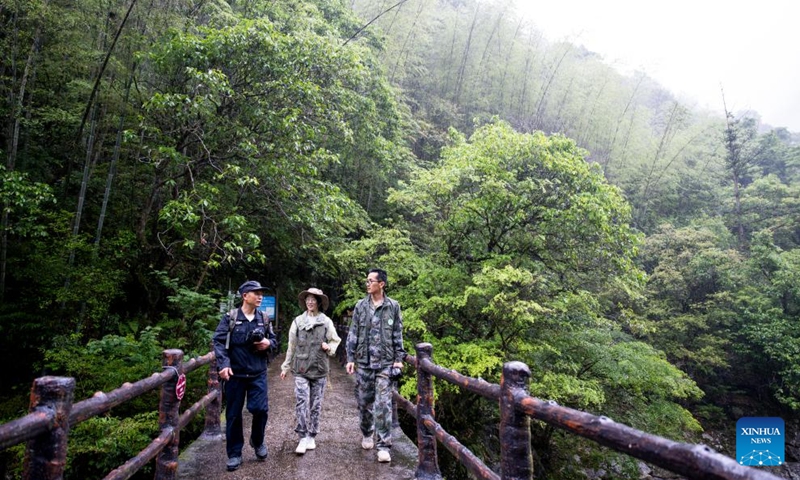 Luo Xianhua (1st L), together with staff members of the Wuyishan National Park, patrols the park in southeast China's Fujian Province, on May 7, 2026. Tea farmer Luo Xianhua from Tongmu, a village nestled deep within the Wuyishan National Park, also serves as a forest ranger for at least 15 days every month. Inscribed on the UNESCO World Heritage List as a mixed cultural and natural heritage site, the national park is home to the world's most well-preserved mid-subtropical forest ecosystem at the same latitude, and plays a critical role in global biodiversity conservation. (Photo: Xinhua)