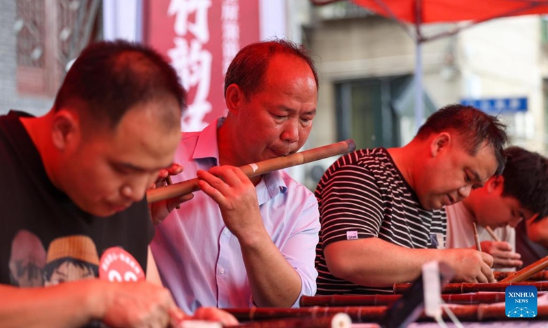 A contestant tunes a bamboo flute during a bamboo flute making skills competition at Yuping Bamboo Flute Museum in Yuping Dong Autonomous County, southwest China's Guizhou Province, May 18, 2026. The competition was held here on Monday to mark the International Museum Day. The Yuping bamboo flutes, made from a kind of local bamboo, are well-known traditional wind instruments in China. The making technique of these flutes was included in the first batch of the National Intangible Cultural Heritage List in 2006. (Photo: Xinhua)