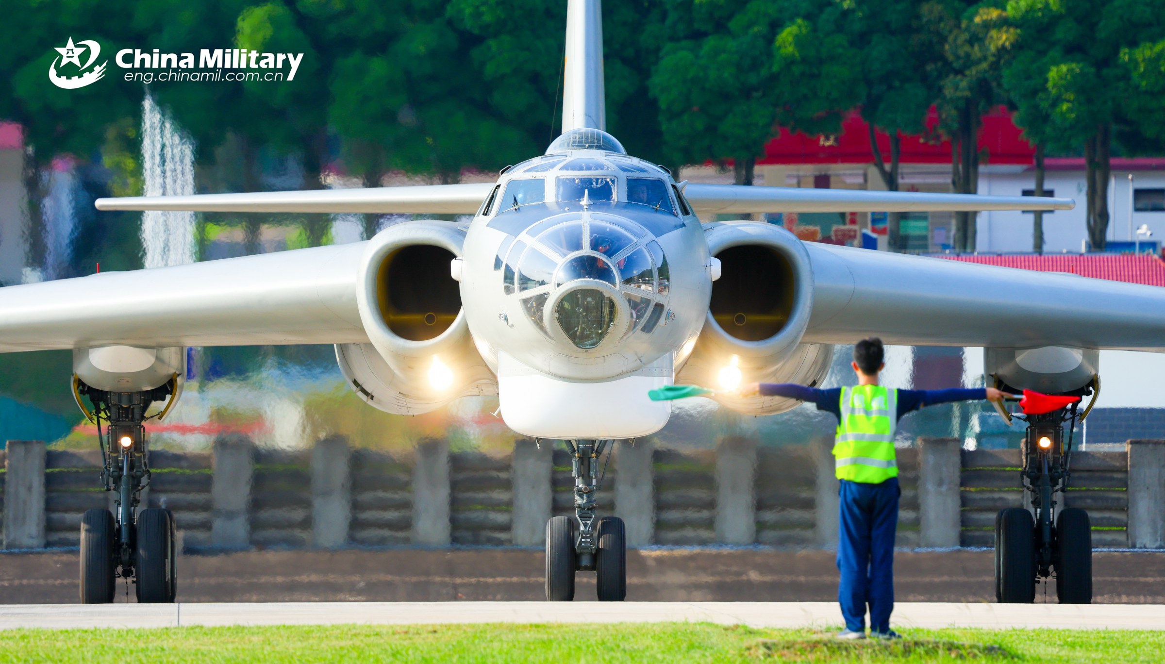 A ground crew member assigned to an aviation regiment under the Chinese PLA Air Force guides an H-6G bomber to the runway during a round-the-clock training exercise in early May, 2026. (Photo: eng.chinamil.com.cn)