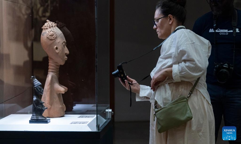 A visitor takes photos of an exhibit at the Museum of Black Civilizations in Dakar, Senegal, on May 15, 2026. May 18 marks the International Museum Day. The Museum of Black Civilizations has emerged as a cultural landmark not only in Senegal but across Africa. It plays a vital role in preserving heritage, advancing academic research, hosting exhibitions, and promoting public education. (Photo: Xinhua)