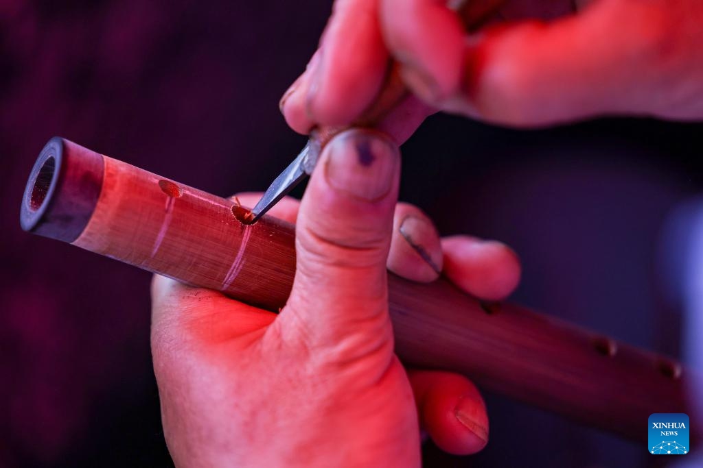 A contestant is in action during a bamboo flute making skills competition at Yuping Bamboo Flute Museum in Yuping Dong Autonomous County, southwest China's Guizhou Province, May 18, 2026. The competition was held here on Monday to mark the International Museum Day. The Yuping bamboo flutes, made from a kind of local bamboo, are well-known traditional wind instruments in China. The making technique of these flutes was included in the first batch of the National Intangible Cultural Heritage List in 2006. (Photo: Xinhua)