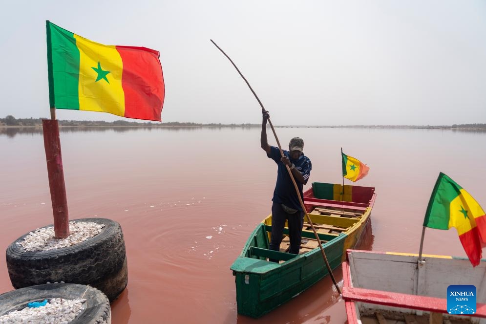 A man rows his boat on the Lake Retba, also known as the Lac Rose, near Dakar, Senegal, on May 17, 2026. The Dakar 2026 Youth Olympic Games will be held from Oct. 31 to Nov. 13 in Dakar, becoming the first Olympic event ever staged on the African continent. (Photo: Xinhua)