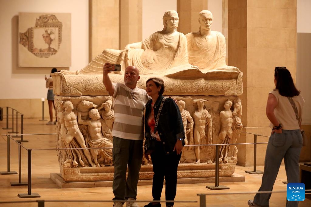 People pose for photos in front of an exhibit at the Beirut National Museum in Beirut, Lebanon, on May 17, 2026. The Beirut National Museum opened its doors to the public free of charge on Sunday, inviting visitors to explore Lebanon's ancient civilizations and archaeological treasures ahead of the International Museum Day which falls on May 18. (Photo: Xinhua)