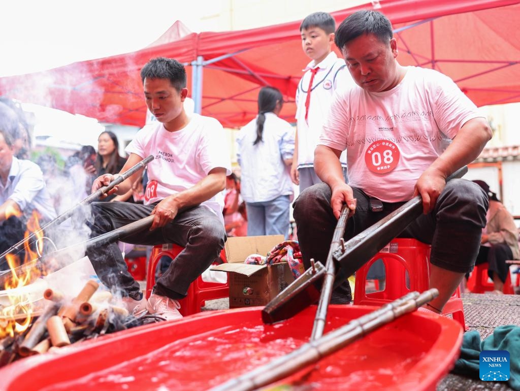 Contestants are in action during a bamboo flute making skills competition at Yuping Bamboo Flute Museum in Yuping Dong Autonomous County, southwest China's Guizhou Province, May 18, 2026. The competition was held here on Monday to mark the International Museum Day. The Yuping bamboo flutes, made from a kind of local bamboo, are well-known traditional wind instruments in China. The making technique of these flutes was included in the first batch of the National Intangible Cultural Heritage List in 2006. (Photo: Xinhua)