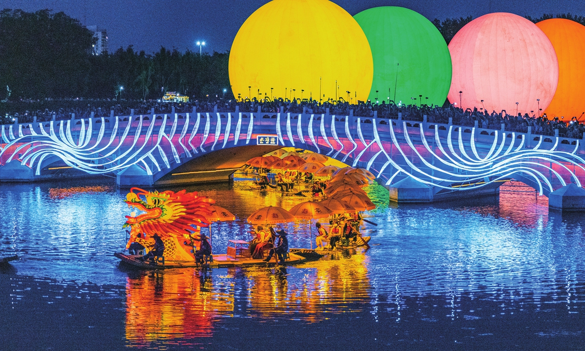 A golden dragon parade across the lake in Chaoyang Park, Beijing on May 18, 2026 
