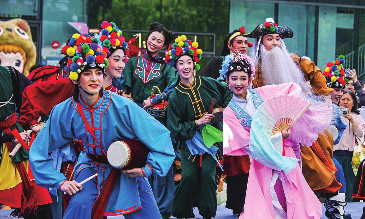 People carry out a Yangko (rural folk dance) national intangible cultural heritage project in the Xiaohongmen area of the Chaoyang district, Beijing at the 2026 China New Cultural and Creative Market and Trend Toy Carnival on May 16, 2026. Photos on this page: VCG